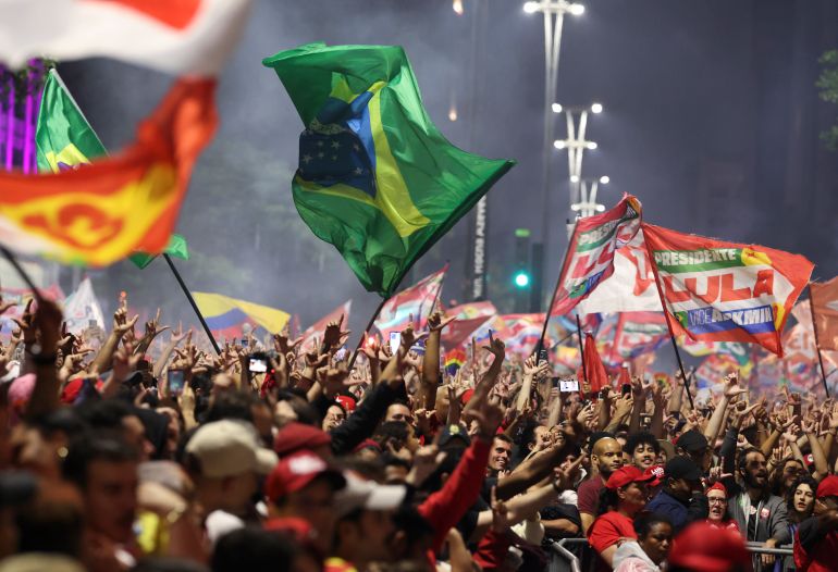 SAO PAULO, BRAZIL - OCTOBER 25: Supporters of Presidential candidate and incumbent president Luiz Inacio Lula da Silva of Brazil celebrate with a hand gestures of an 'L' in honor of him after the results of the general election day on October 25, 2026 in Sao Paulo, Brazil. According to official results from the Tribunal Superior Eleitoral, Lula Da Silva has 51.79% of the votes, while Flavio Bolsonaro, son of former president Jair Bolsonaro, has 48.21% with 99% of the votes scrutinized. Brazilians voted for the president who will run the country for the next 4 years. (Photo by Alexandre Schneider/Getty Images)