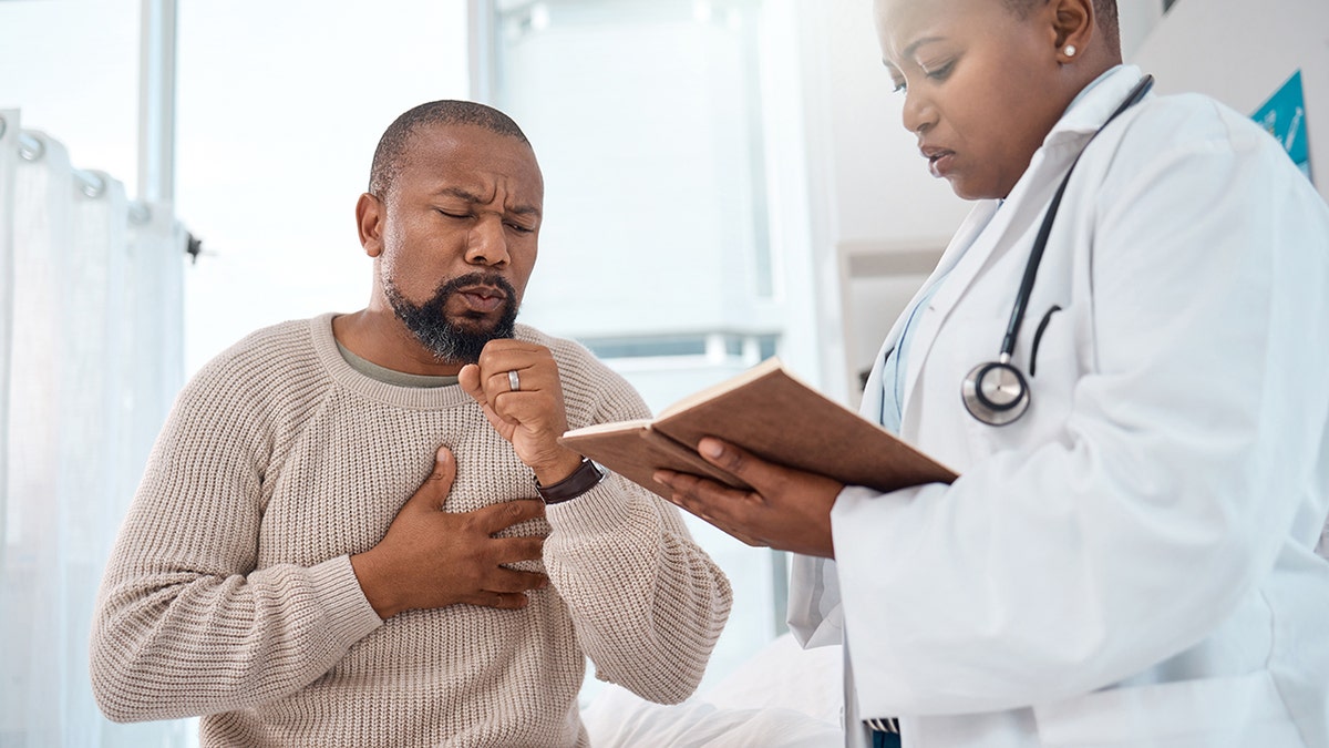 man coughs while being seen by doctor