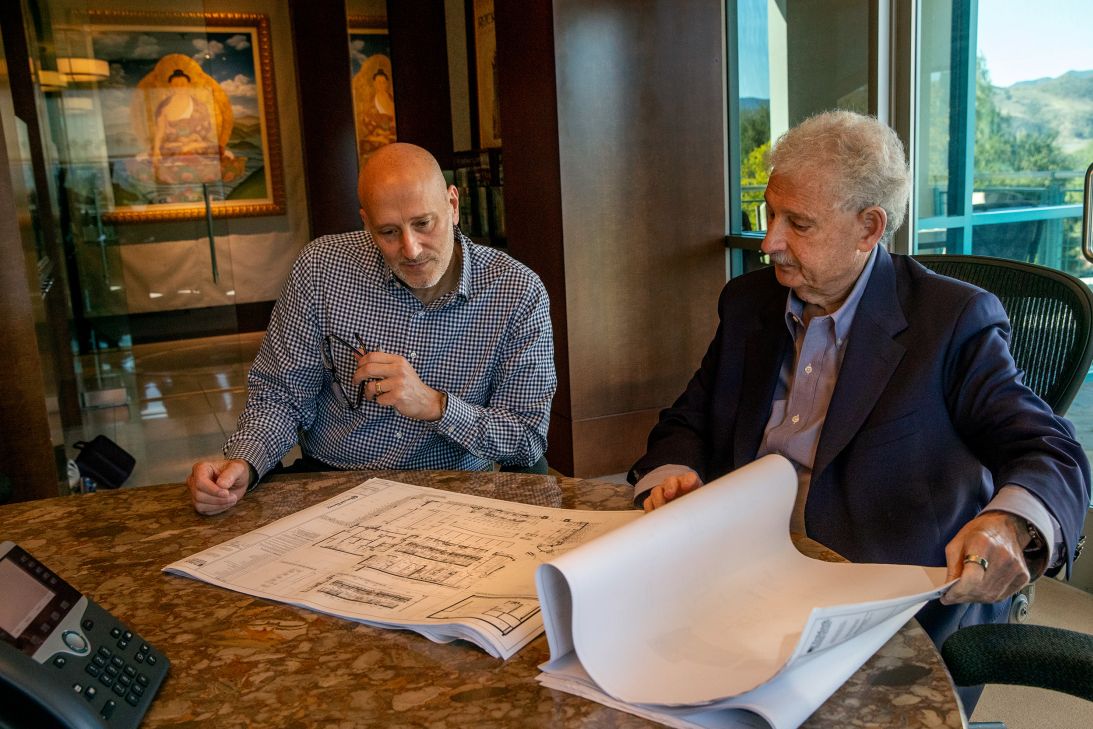 David Gordon, president of the Cheesecake Factory, and David Overton, CEO and chairman, who founded the chain with his parents, examining blueprints for a new restaurant in Texas in 2023. With so many materials inside, the price of building a new location isn't cheap.