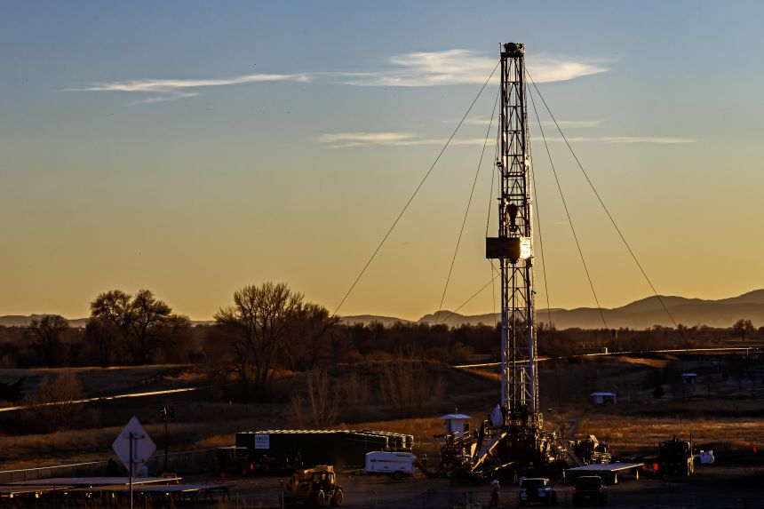 An oil drilling rig is seen northeast of Denver in Lochbuie, Colorado.
