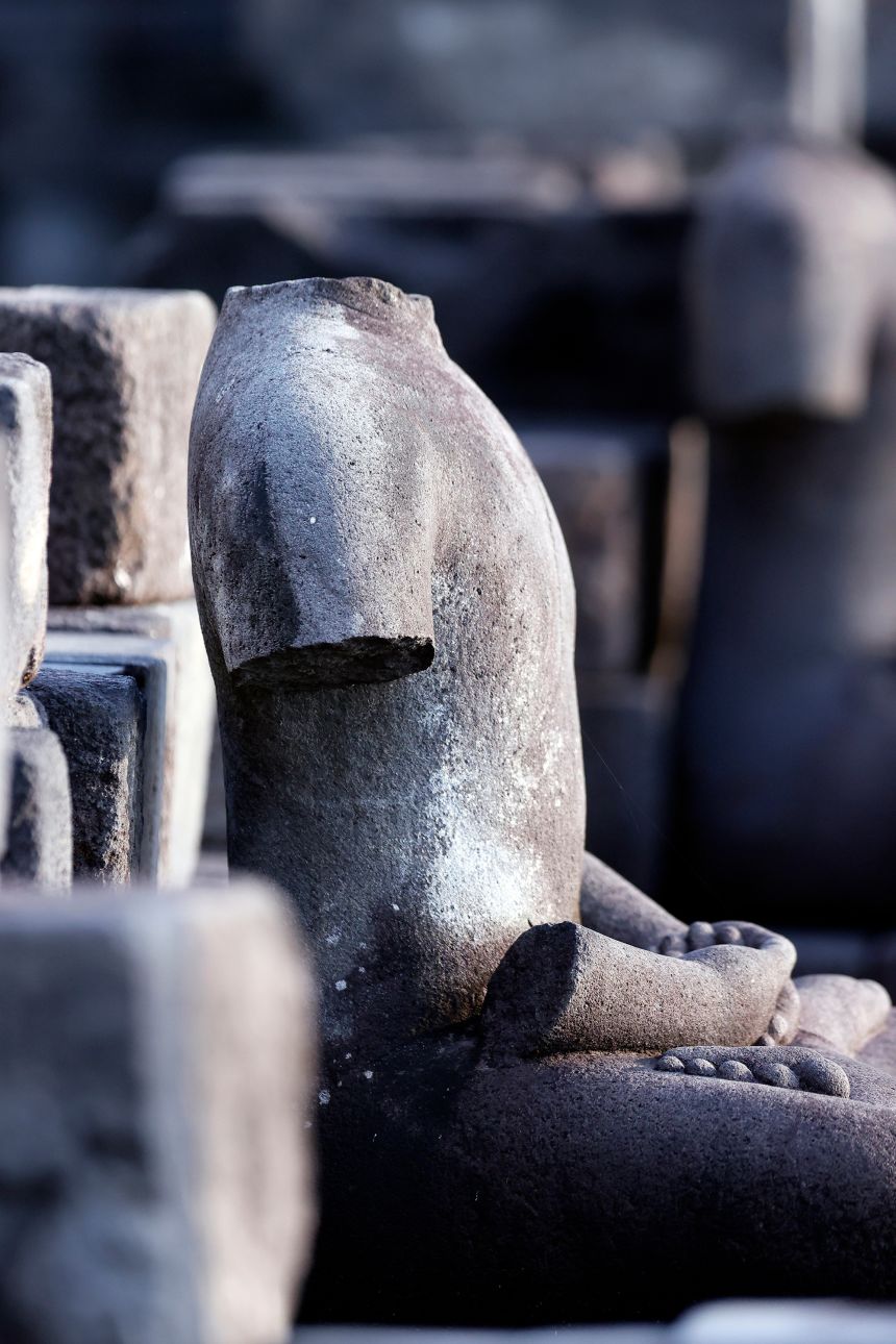 Many of Borobudur's Buddha statues, like the one shown here, are missing heads or arms.