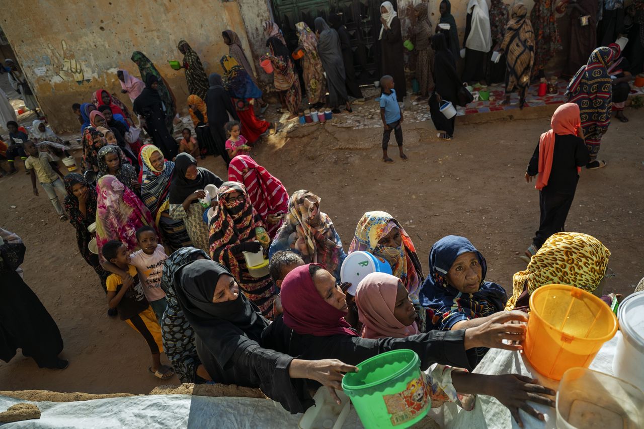 Sudanese families fleeing RSF territory wait for food at an Emergency Response Room communal kitchen in Bir Hamada, in Khartoum state, Sudan, on March 17, 2025.