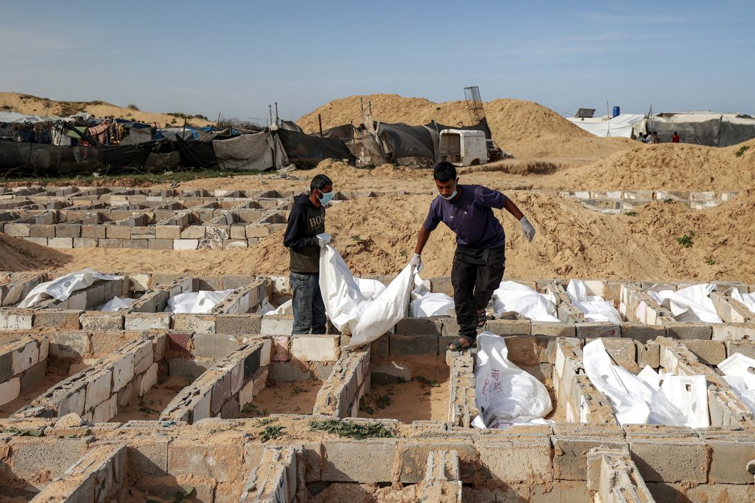 Young men conduct burials at the cemetery of the missing in Deir al-Balah, central Gaza on February 13.