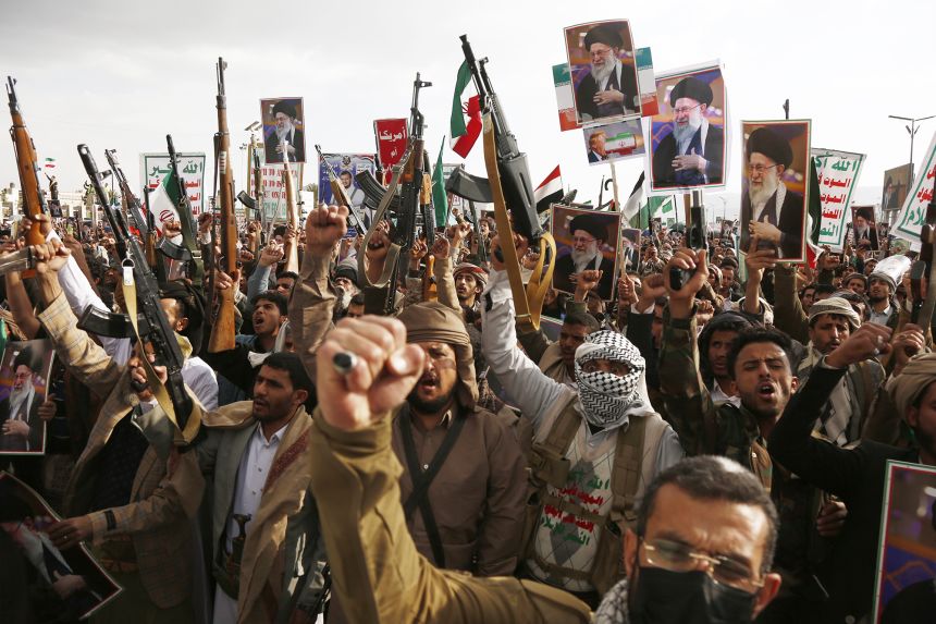 Protesters brandish billboards depicting the late Iranian Supreme Leader Ali Khamenei, flags of Yemen and Iran, and weapons as they take part in a rally held to condemn the US-Israel attacks on Iran that killed Khamenei, in Sana'a, Yemen, on March 1.