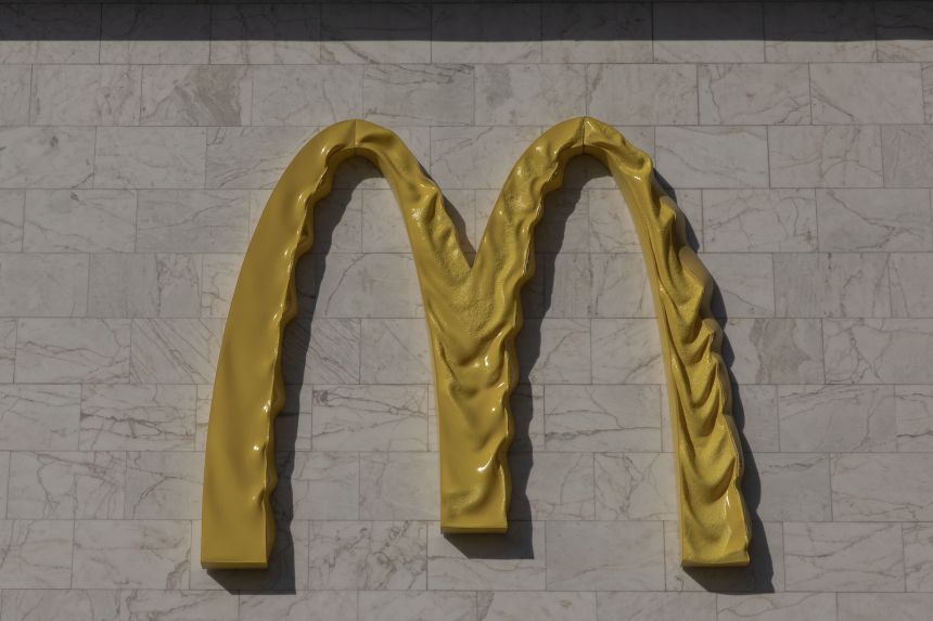 This photograph shows a McDonald's logo displayed on the facade of one of its restaurants, damaged and melted by Russian strikes near the Lukianivska metro station in Kyiv on May 27, 2026.