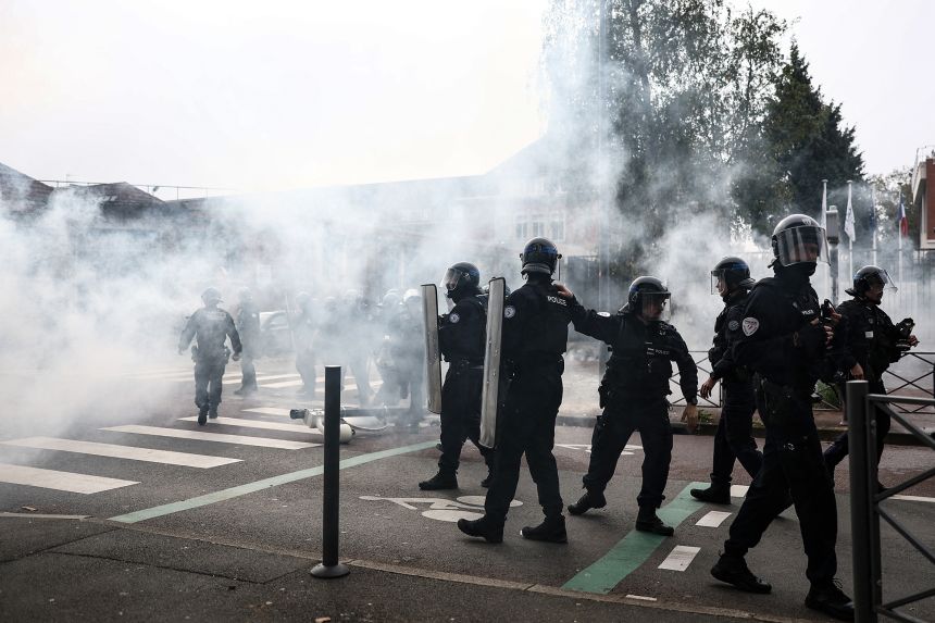 French police fire teargas as students carry out a protest at the César Baggio secondary school in Lille, on Tuesday.