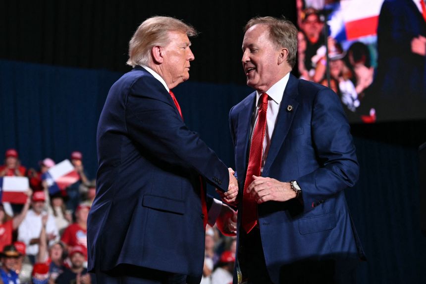 President Donald Trump shakes hands with Ken Paxton during a campaign rally in San Antonio on October 7.
