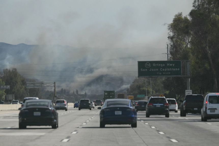 Cars drive along Interstate 5 towards the Norte Fire in San Juan Capistrano, California, on October 16. Evacuation orders have been issued for parts of Orange County.