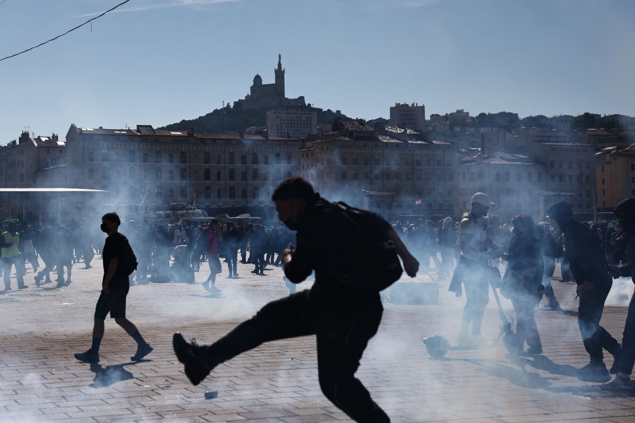 A protester kicks back a tear gas canister during a demonstration in Marseille, southern France, on October 17.
