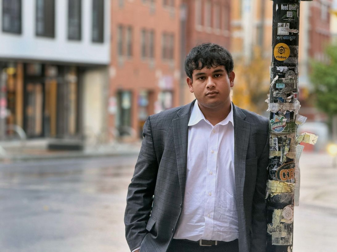 Eeshaan Chaudhuri poses outside Collegetown Bagels in Ithaca on Friday.