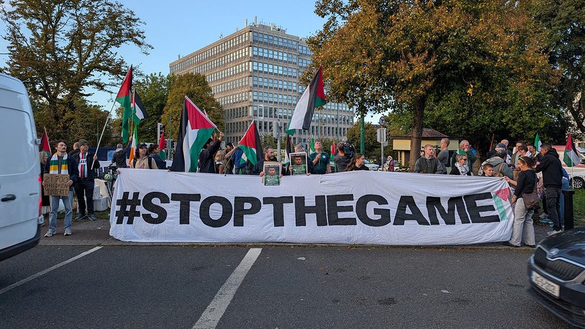 People stand near the Aviva Stadium in Dublin calling to boycott a soccer game against Israel.