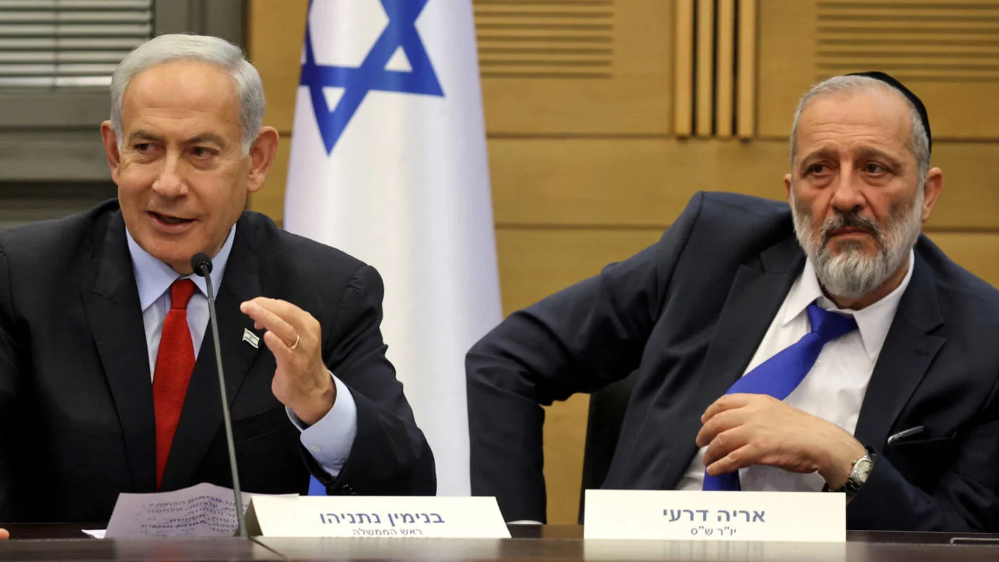 Israeli Prime Minister Benjamin Netanyahu, left, and Aryeh Deri, of the Shas party at the Knesset, Jerusalem, in May 2023 (AFP)