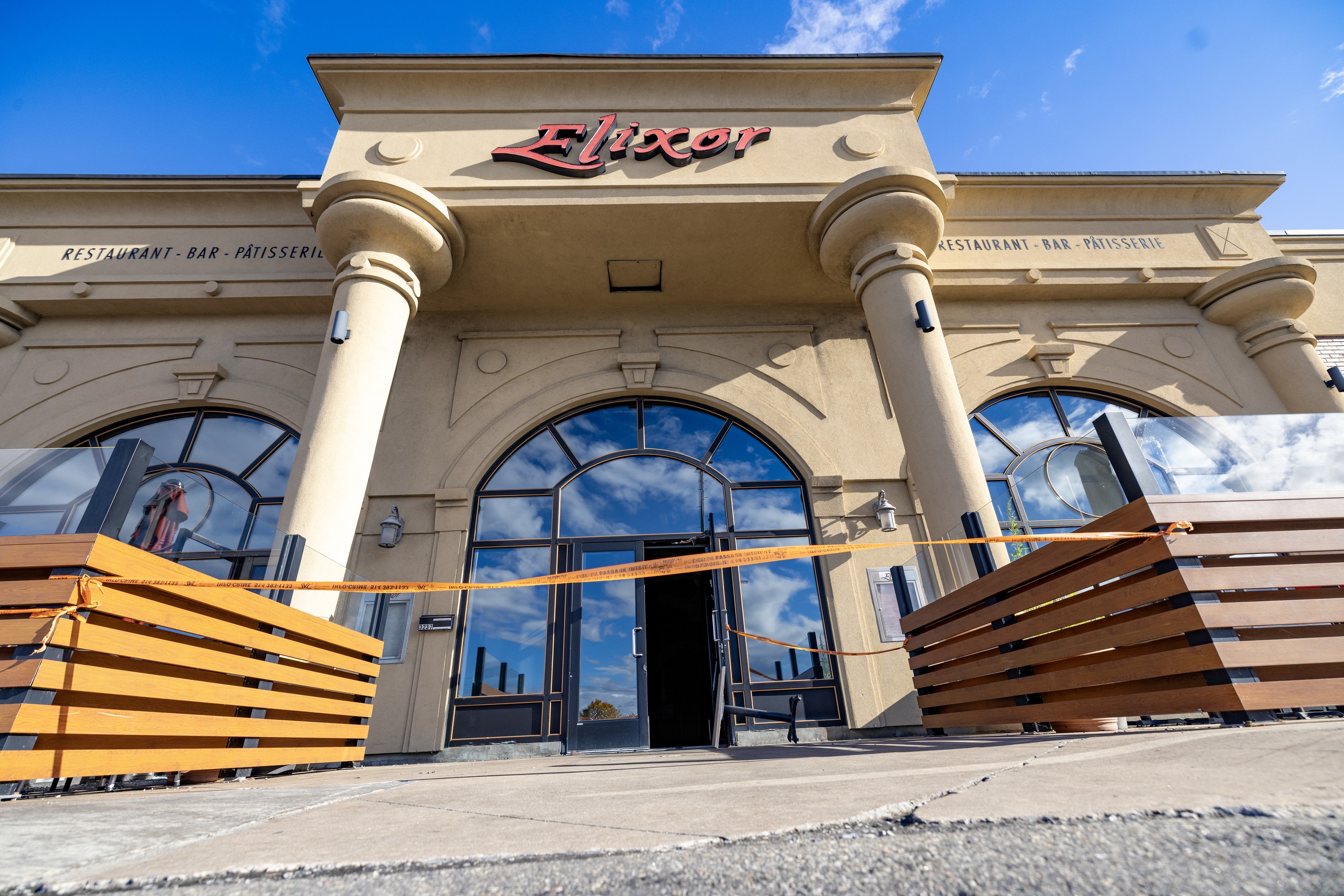 The front of Elixor restaurant with police tape across the entrance.