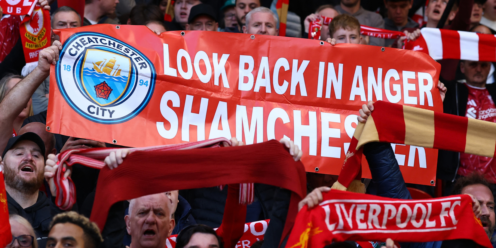 Liverpool fans showing banner shaming Manchester City