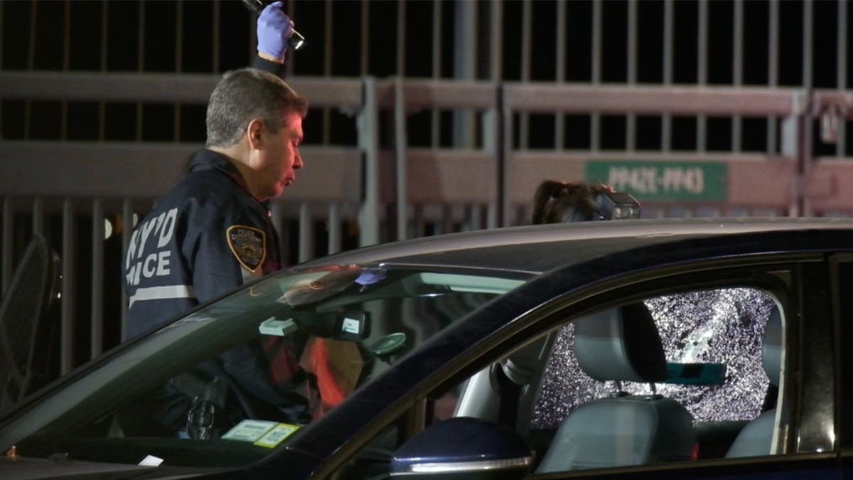 image shows car with smashed window