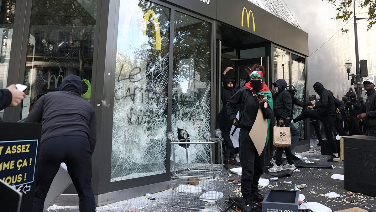 Protesters vandalize a McDonald's restaurant amid clashes during a day of demonstrations against the cost of living and rising fuel prices in Paris as part of nationwide protests called by the 
