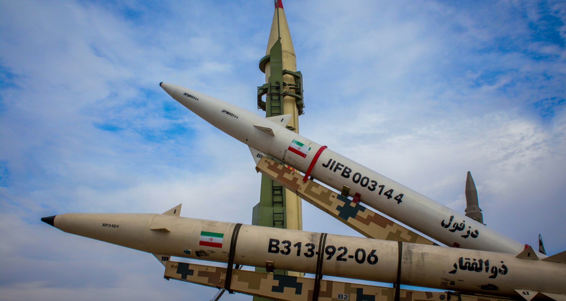 A photo shows Iranian flags on missiles, January 2025 (Moslem Daneshzadeh/Unsplash)