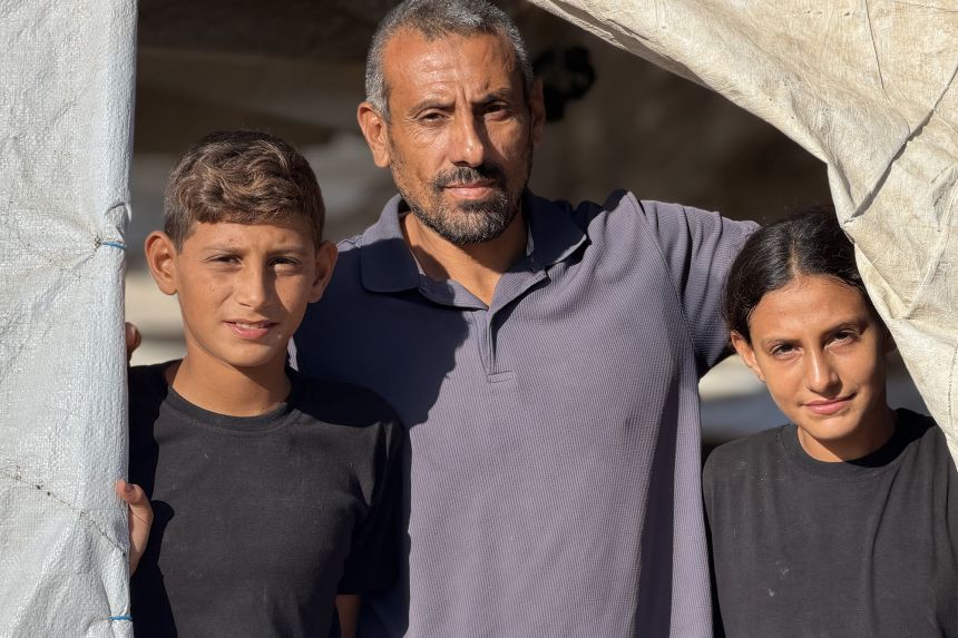 Mohammad Yousef Shalayel (center), shown with two of his children, recalled the “horrific sight” of his relatives’ bodies after an Israeli strike in Jabalya, northern Gaza in November, 2024.