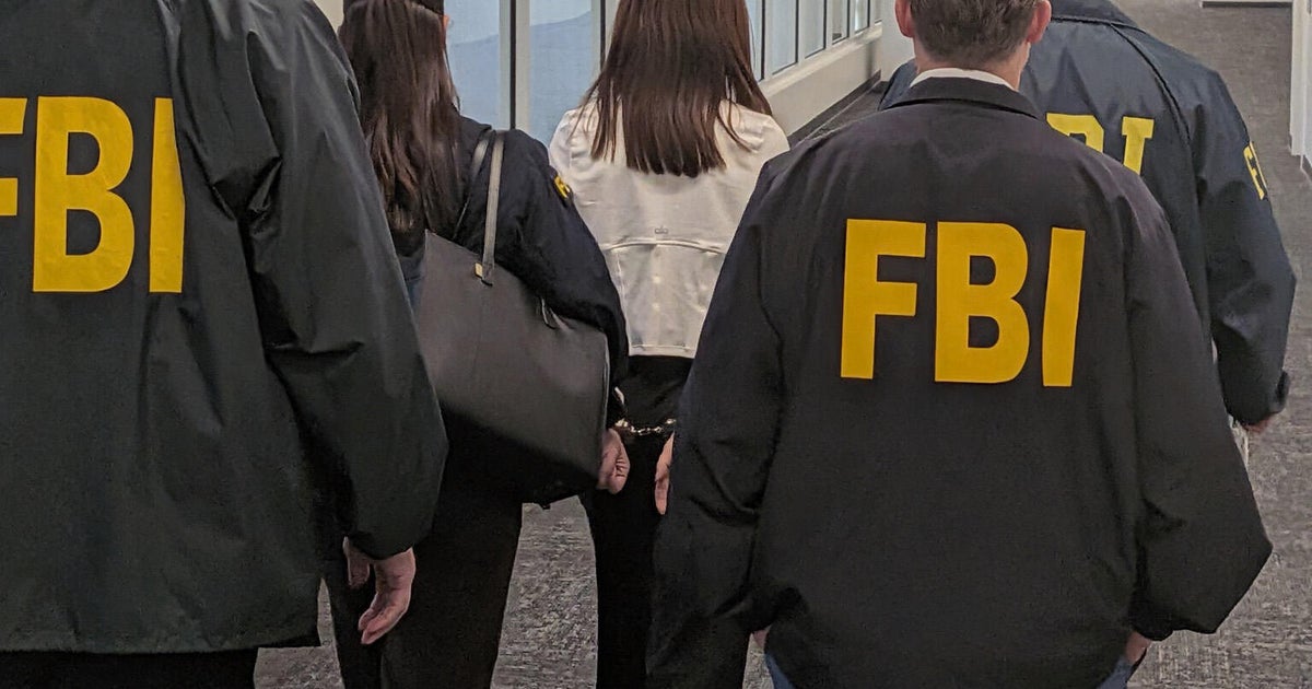 FBI agents walk with Wanying