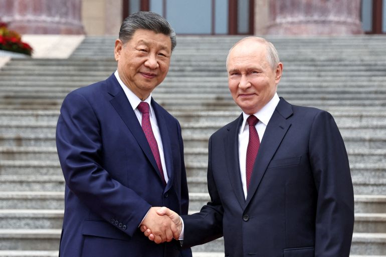 Russian President Vladimir Putin shakes hands with Chinese President Xi Jinping during a welcoming ceremony at the Great Hall of the People in Beijing, China May 20, 2026. Sputnik/Alexander Kazakov/Pool via REUTERS ATTENTION EDITORS - THIS IMAGE WAS PROVIDED BY A THIRD PARTY. TPX IMAGES OF THE DAY