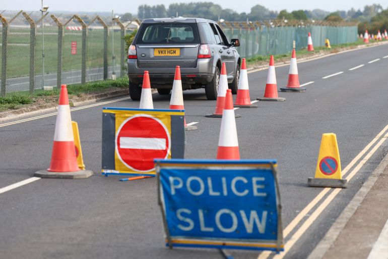 A resident drives to return home near the RAF Fairford airbase, after police declared a major incident at the base and arrested several men on suspicion of offences under the Explosives Act, who have since been released on bail, in Fairford, Gloucestershire, Britain, September 29, 2026. REUTERS/Toby Shepheard