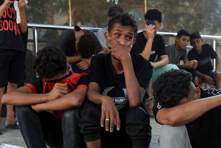 Mourners react during the funeral of three Palestinians who were killed in an Israeli strike, according to medics, at Al-Shifa Hospital in Gaza City, October 25, 2026. REUTERS/Dawoud Abu Alkas