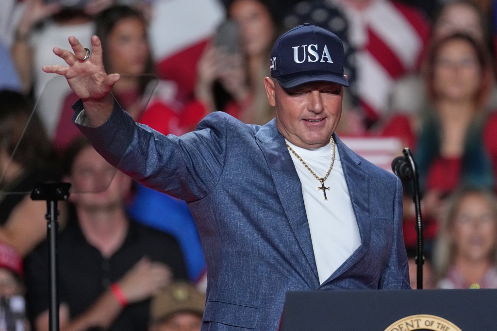Roger Clemens waving to the audience at a campaign rally.