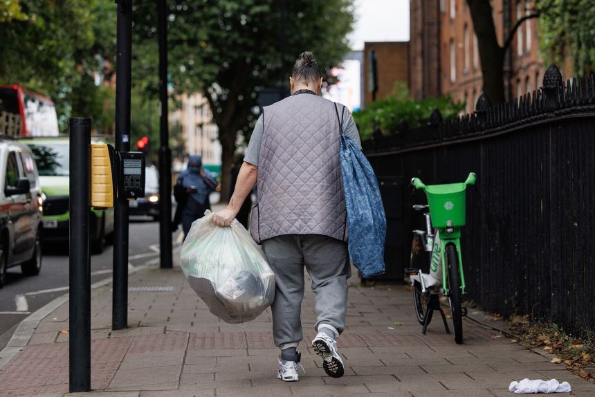 A former prisoner pictured walking away with his belongings after being released from HMP Pentonville in London in 2024.