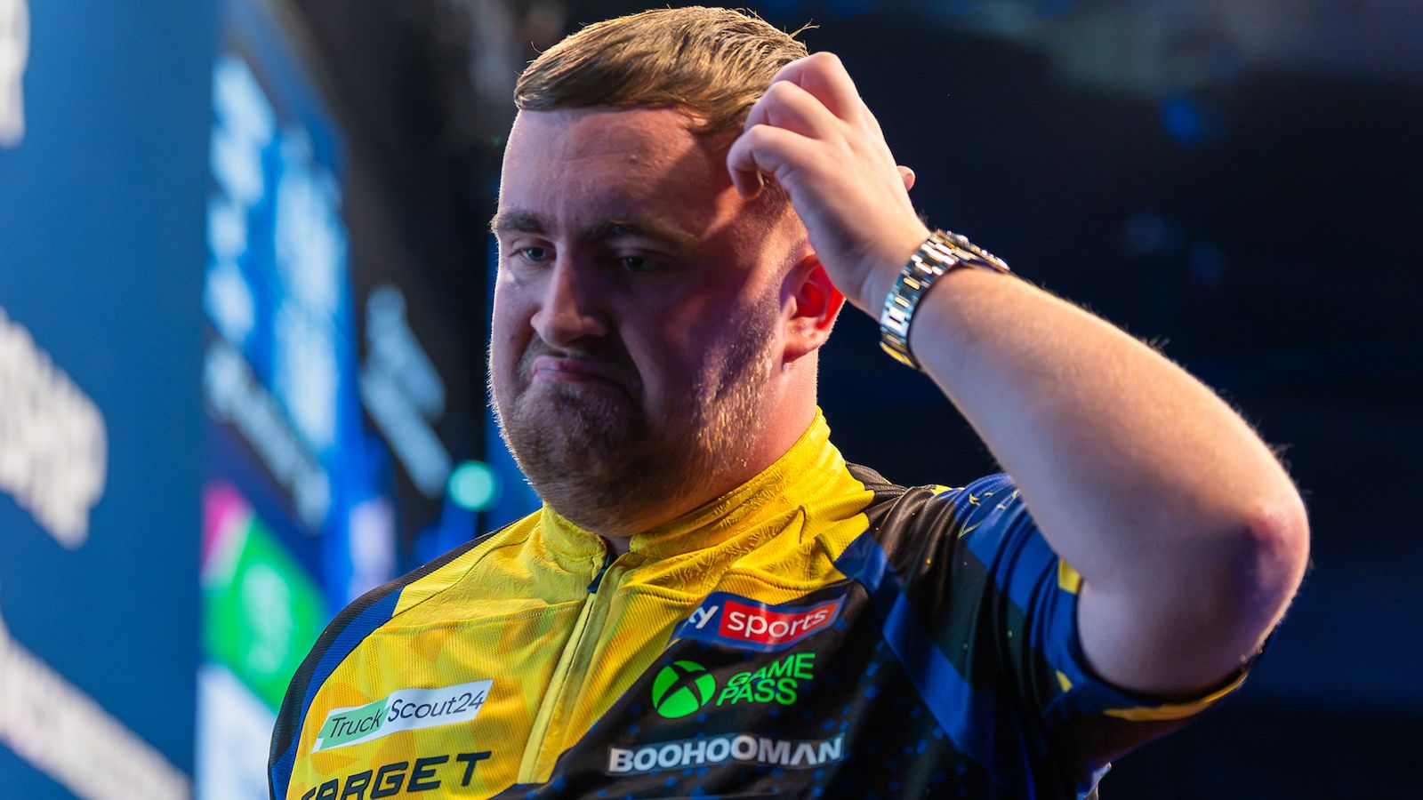 Luke Littler scratches his head during his shock defeat at the European Championship Darts (Pic: Sebastian Doppstadt/PDC)