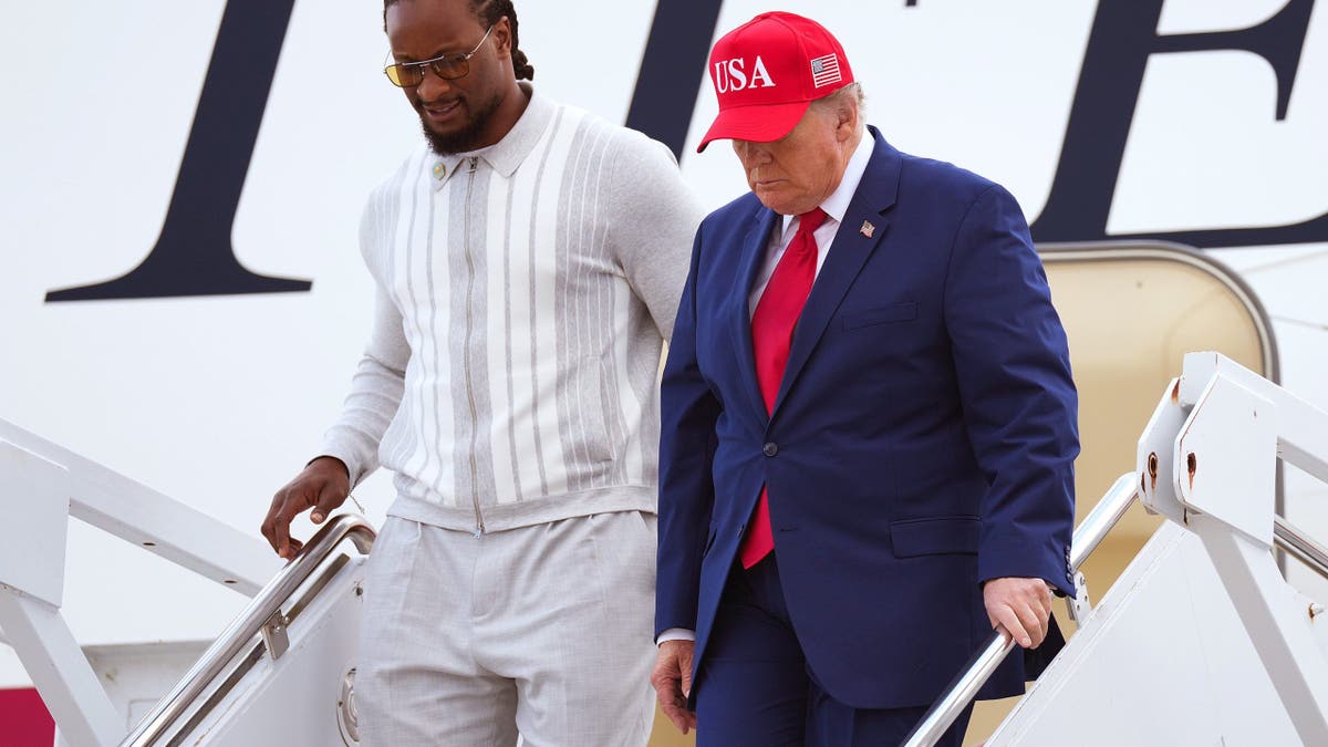Donald Trump and Todd Gurley walk off Air Force One in Marietta, Georgia.