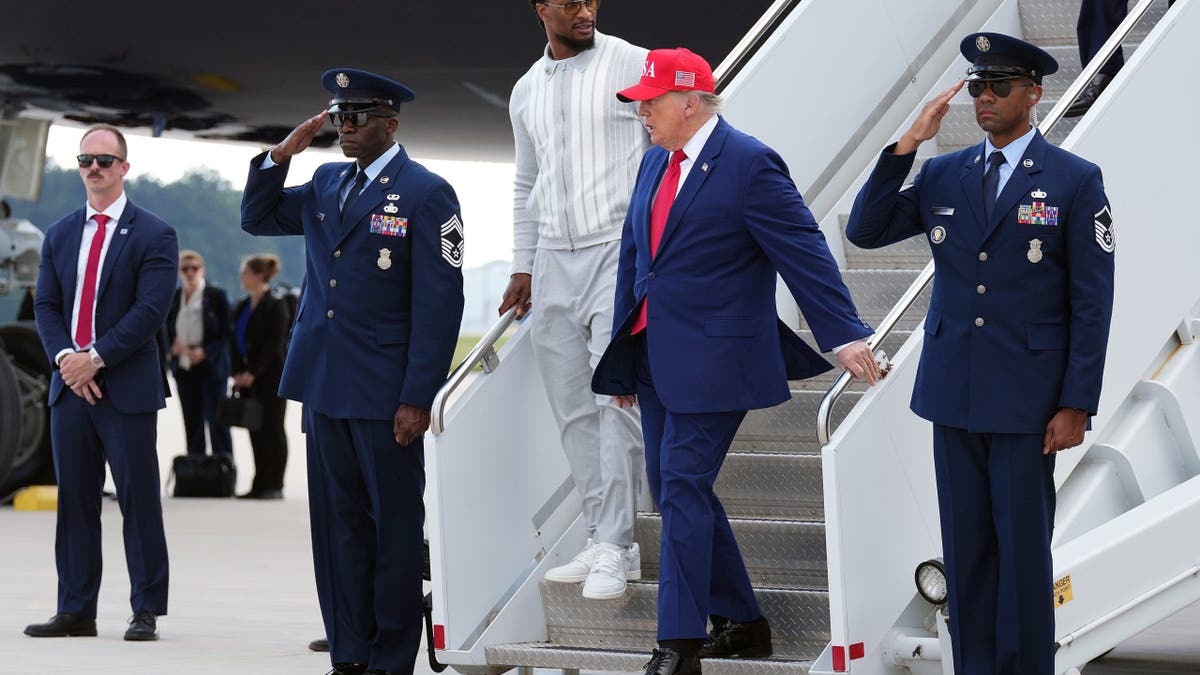 President Donald Trump and Todd Gurley walk off Air Force One at Dobbins Air Reserve Base.