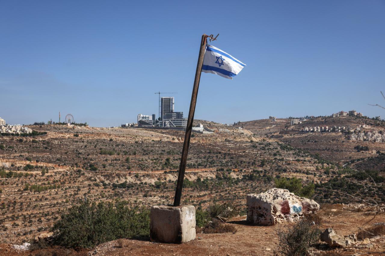 An Israeli flag installed by the illegal settlers is pictured in the al-Tireh neighborhood at the western entrance to Ramallah, in the Israeli-occupied West Bank, Sept. 27, 2026. (AFP Photo)