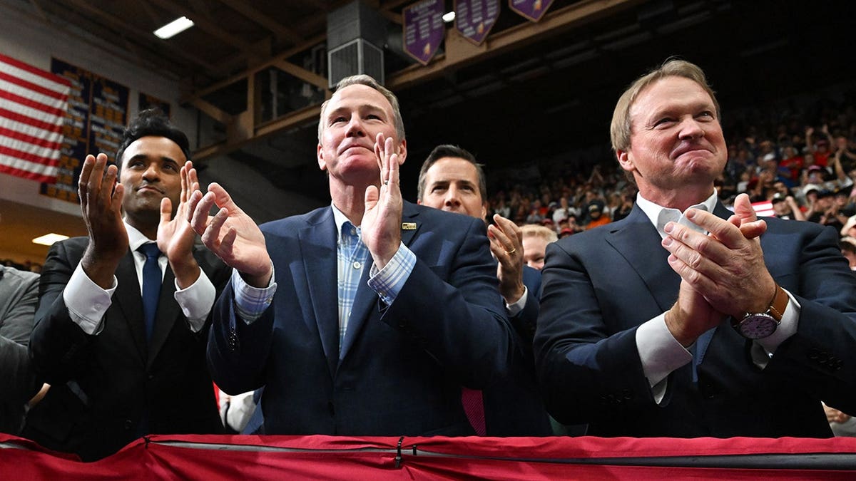 Vivek Ramaswamy, Jon Husted and Jon Gruden listen as Donald Trump speaks at a rally in Vandalia, Ohio.
